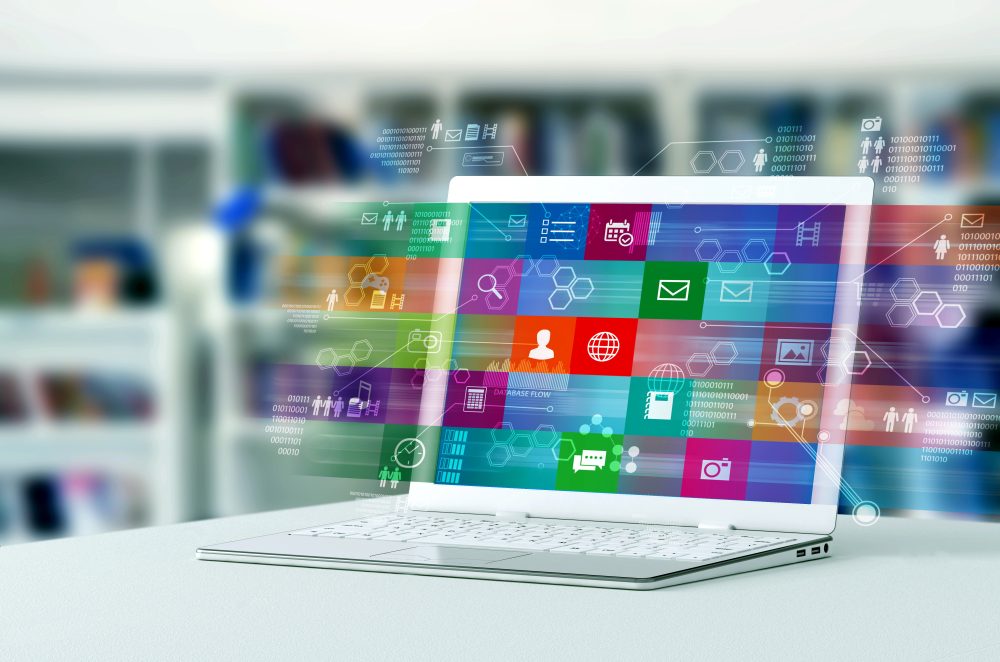 A laptop computer shows a process of browsing application and multimedia content on internet. 